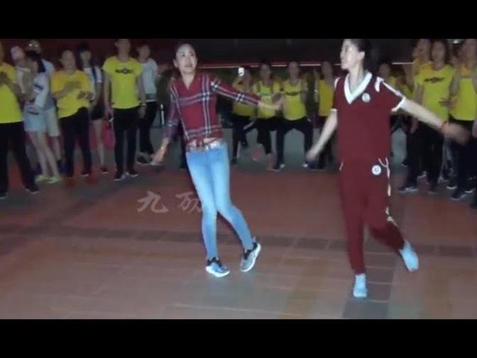 Teacher Dandan and girl, performing for students to shuffle Dance Bairongweika in Beijing