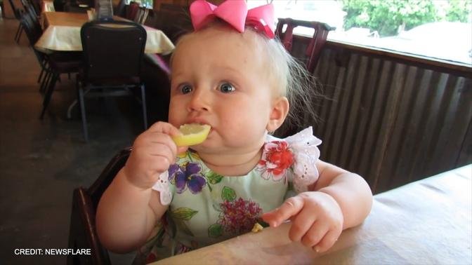 Baby eats a lemon for the first time