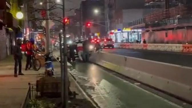Kind New Yorkers stop to help push stuck car off concrete barrier before going about their night