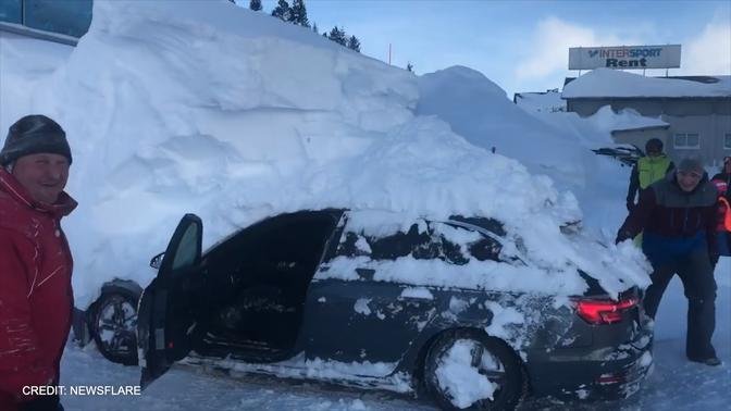 Parked car reverses while under 6ft-high snowdrift in Austrian hotel car park